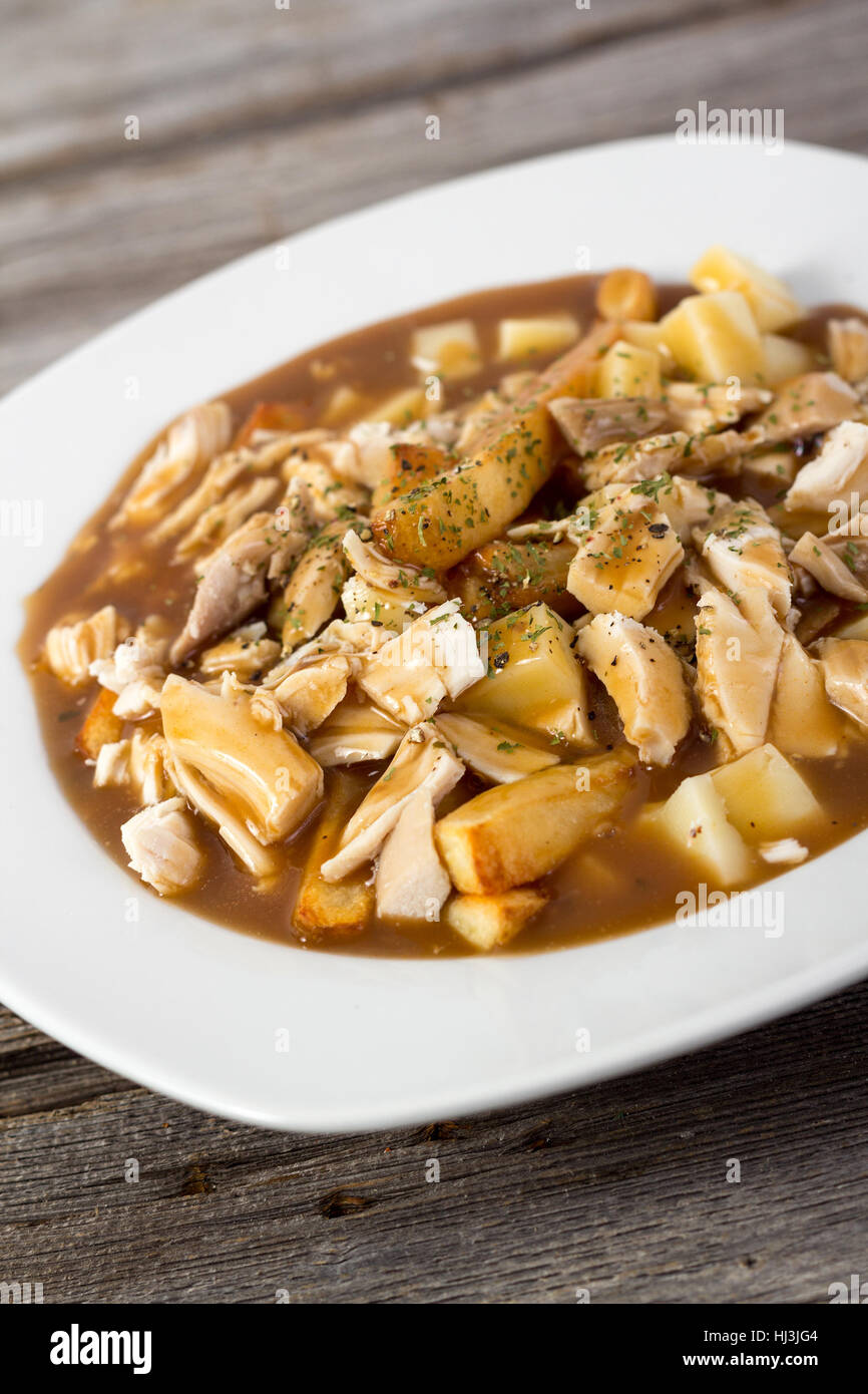 chicken poutine quebec cuisine made with gravy fried cheese curd and chicken Stock Photo