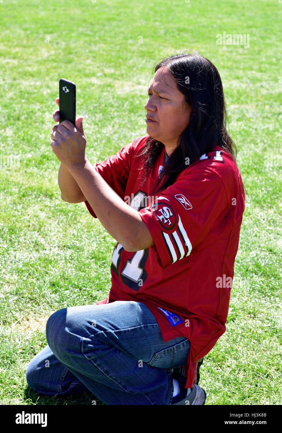 Navaho Native American Indian man at Prescott Inter-tribal Pow Wow Arizona taking photo with cell phone Stock Photo