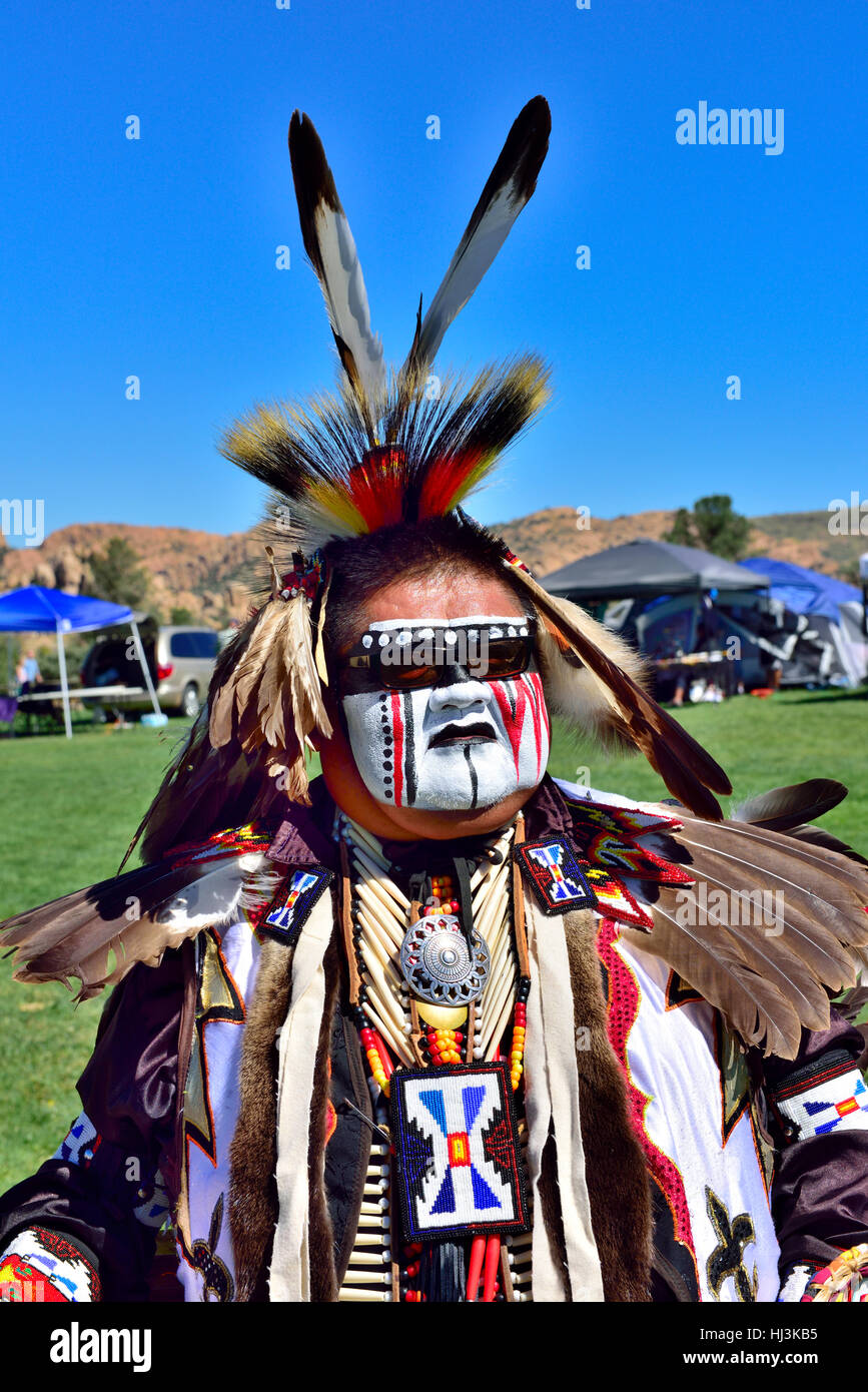 Navaho Native American Indian man at Prescott Inter-tribal Pow Wow Arizona in traditional ceremonial dress with face paint Stock Photo