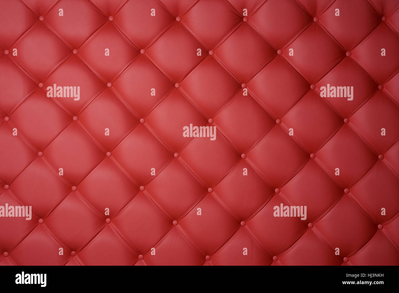 Red leather carriage upholstery as a background. Stock Photo