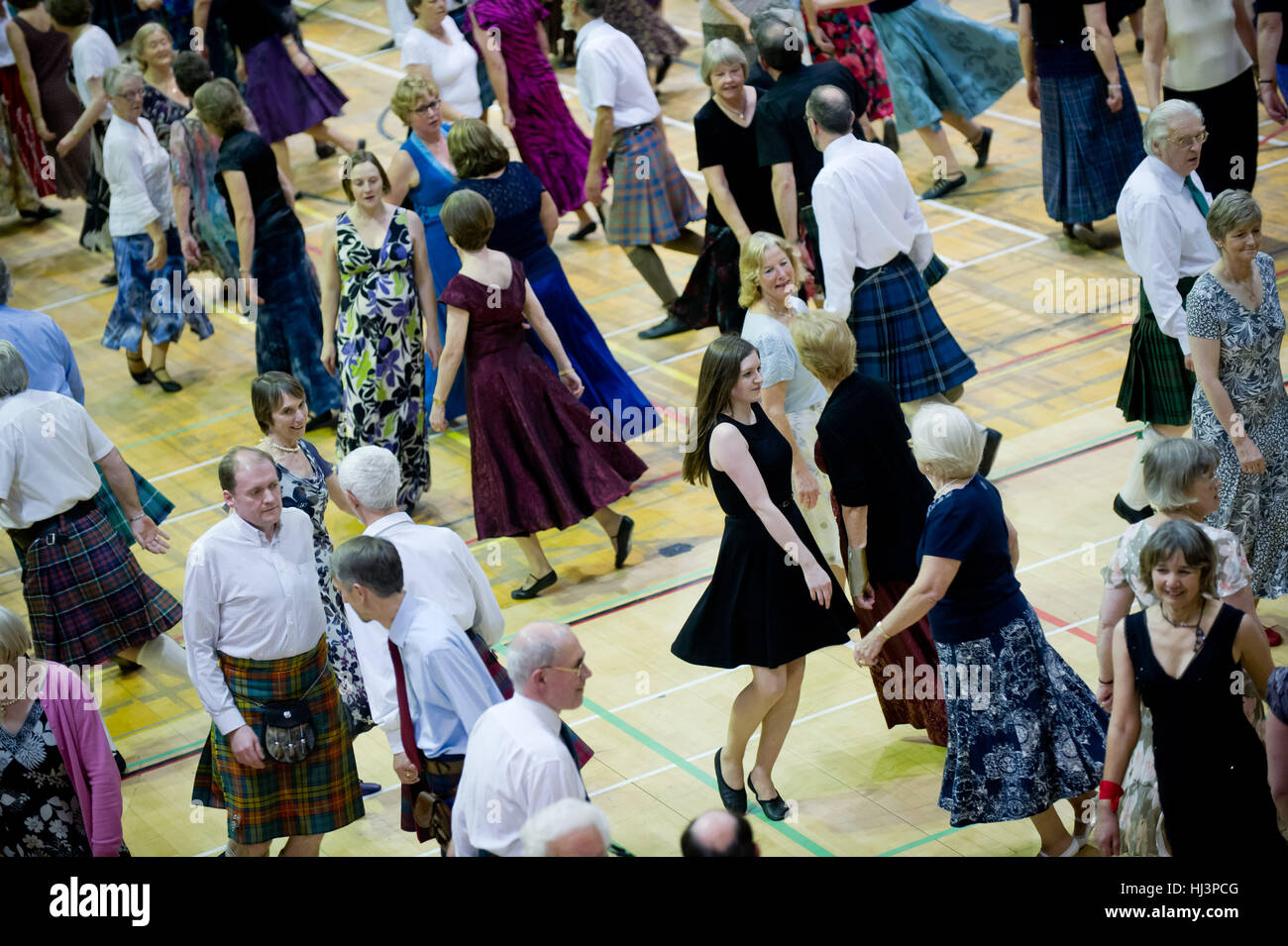 Large group of people partaking in Scottish Country Dancing. Stock Photo