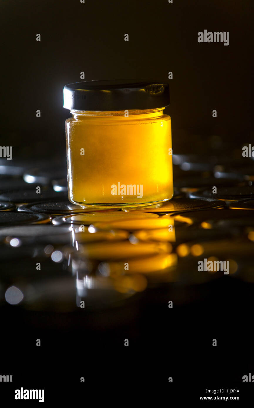 Natural honey production and bottling in jars for retail. Stock Photo
