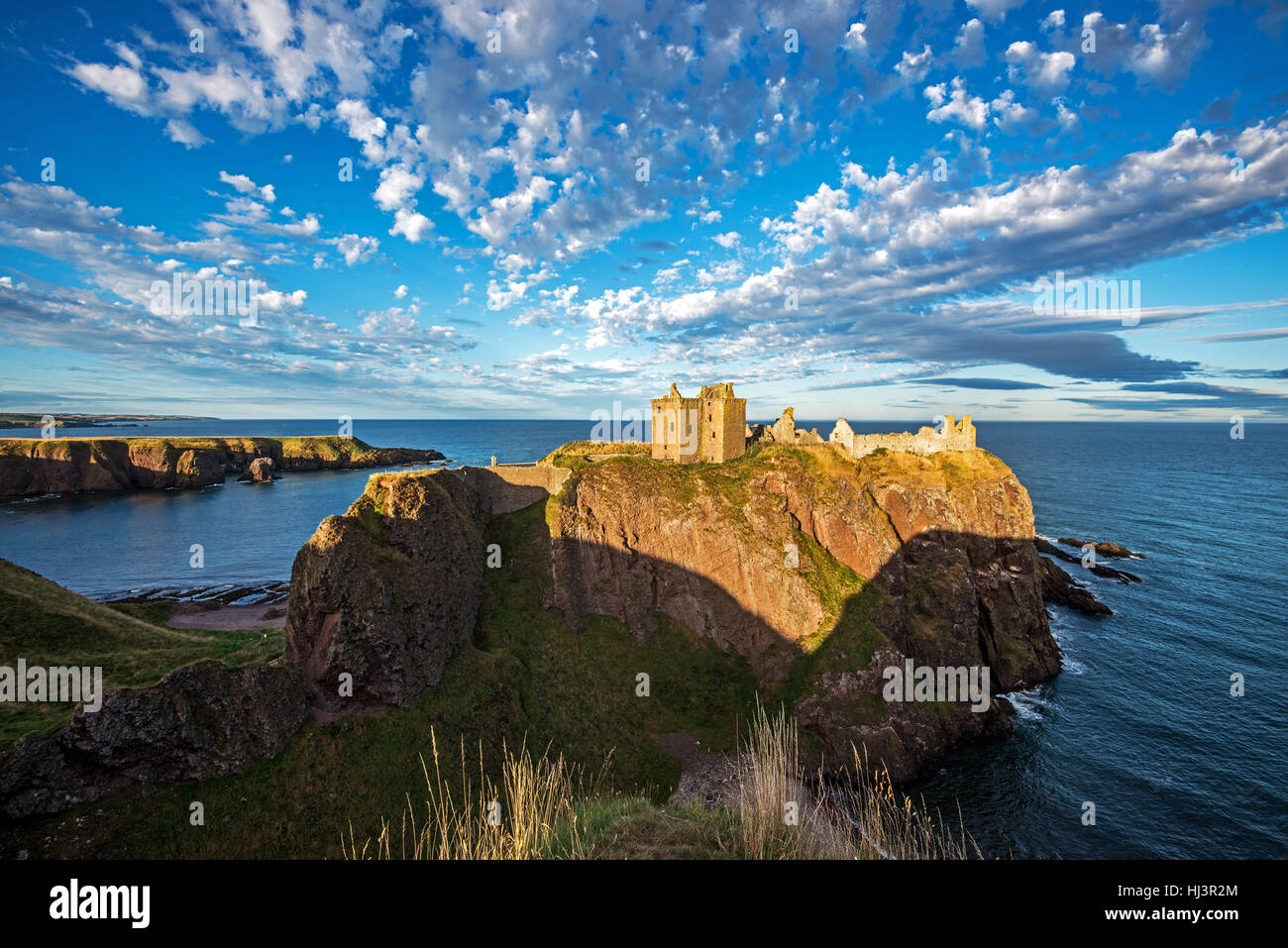 Dunnottar Castle is a ruined medieval fortress located on a rocky headland on the north east of Scotland, near to Stonehaven Stock Photo