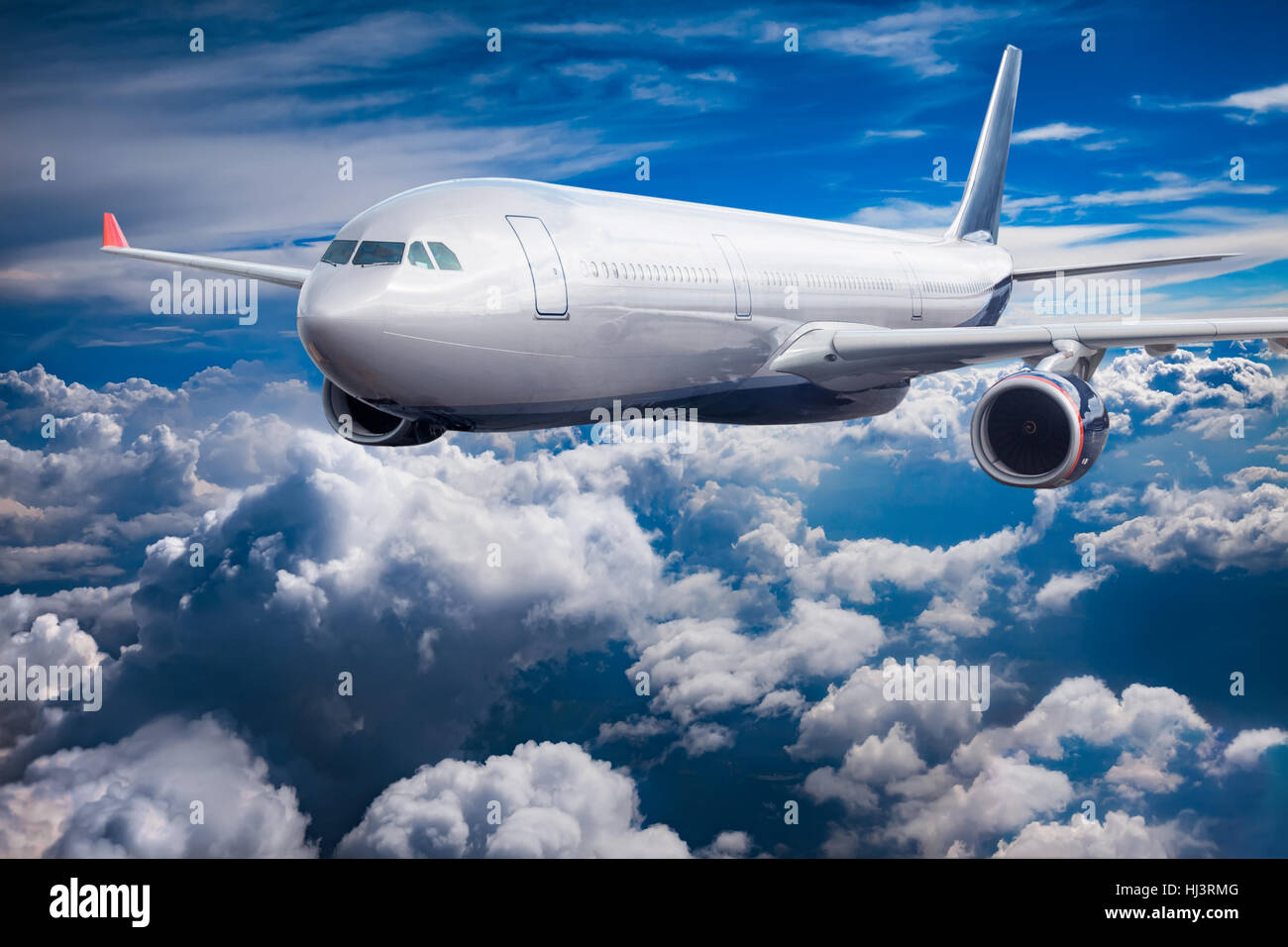 Passenger Airliner flying in the clouds Stock Photo - Alamy