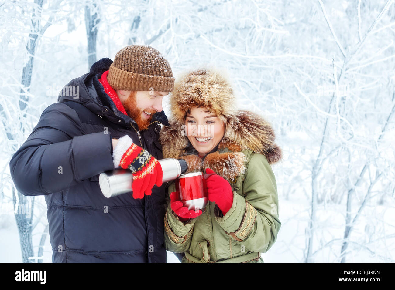 couple drinking tea outdoors in winter Stock Photo