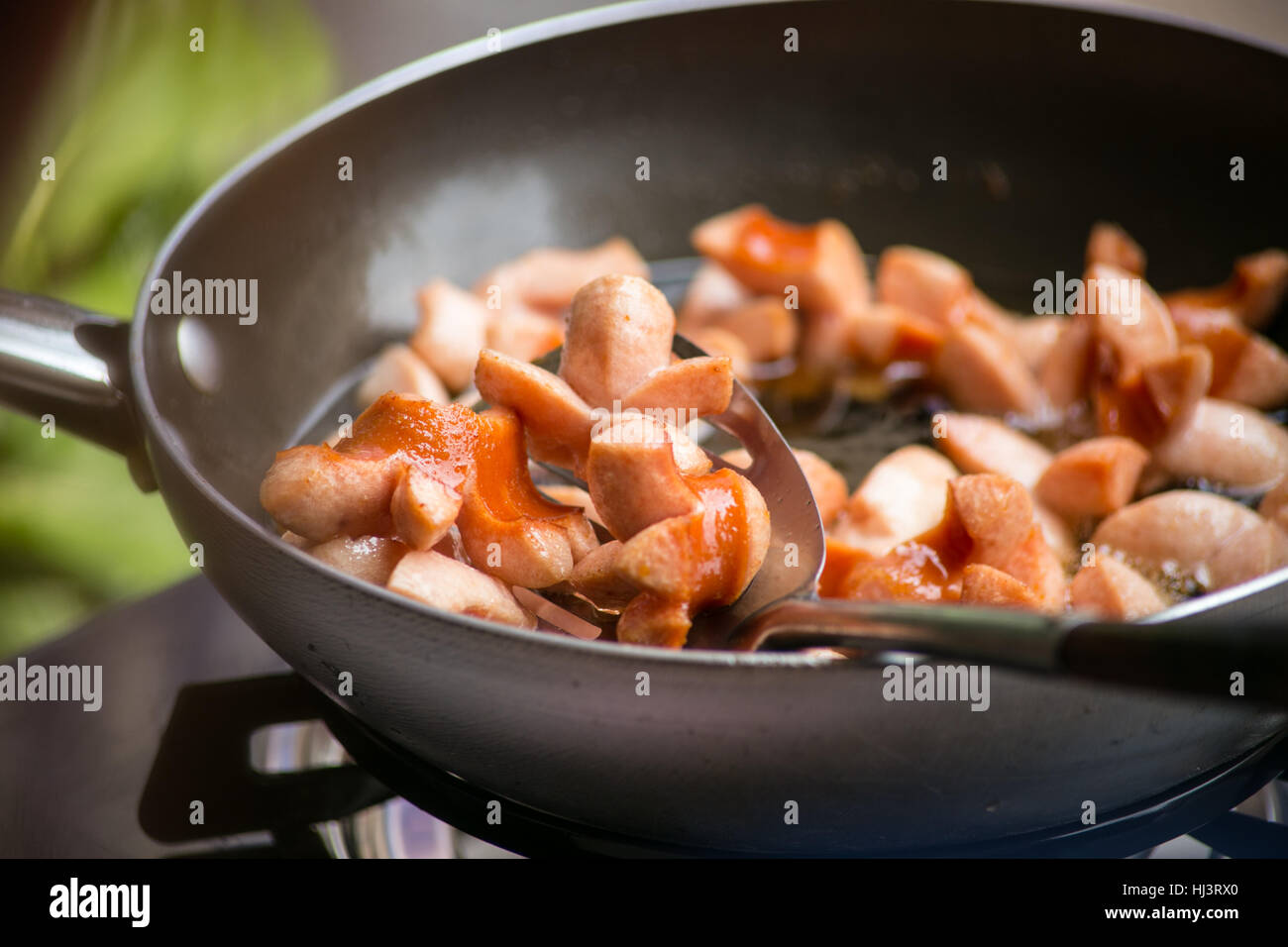 Shredded sausage deep frying in hot oil Stock Photo Alamy