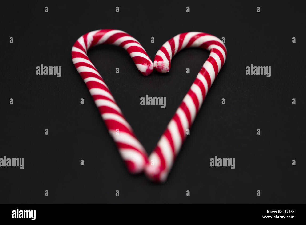 Two Candy Canes Making a Heart Stock Photo - Alamy