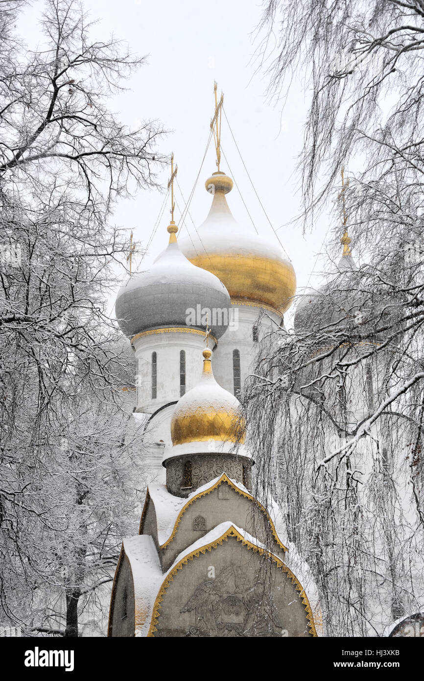 Snow Covered Church Cupolas of Novodevichy Convent Framed by Trees. Moscow, Russia Stock Photo