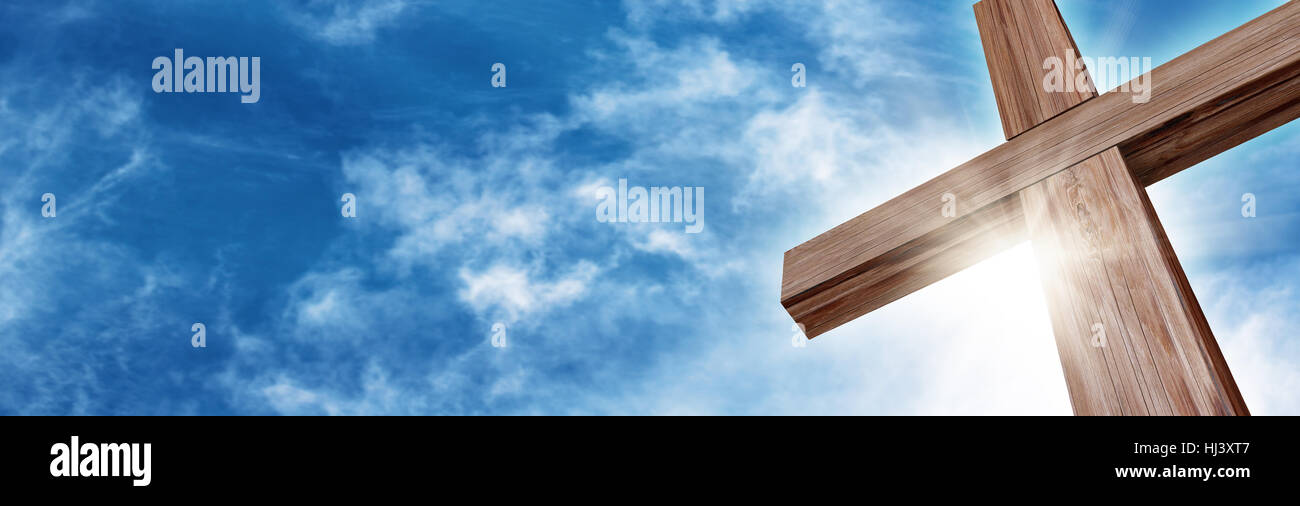 Wooden Cross with a Bright Blue Sky and Sun Stock Photo