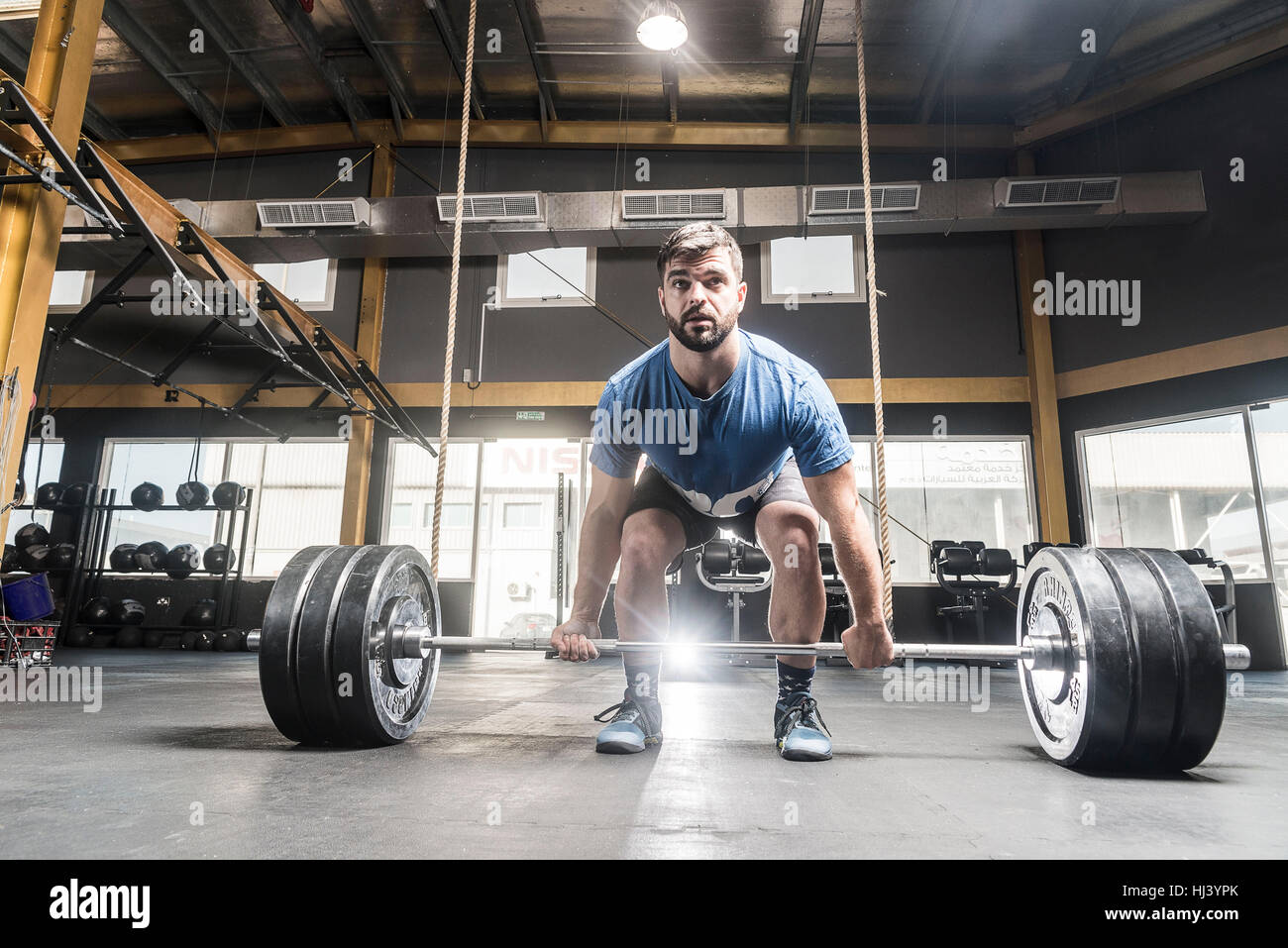 Strong caucasian white man deadlifts in crossfit box Stock Photo