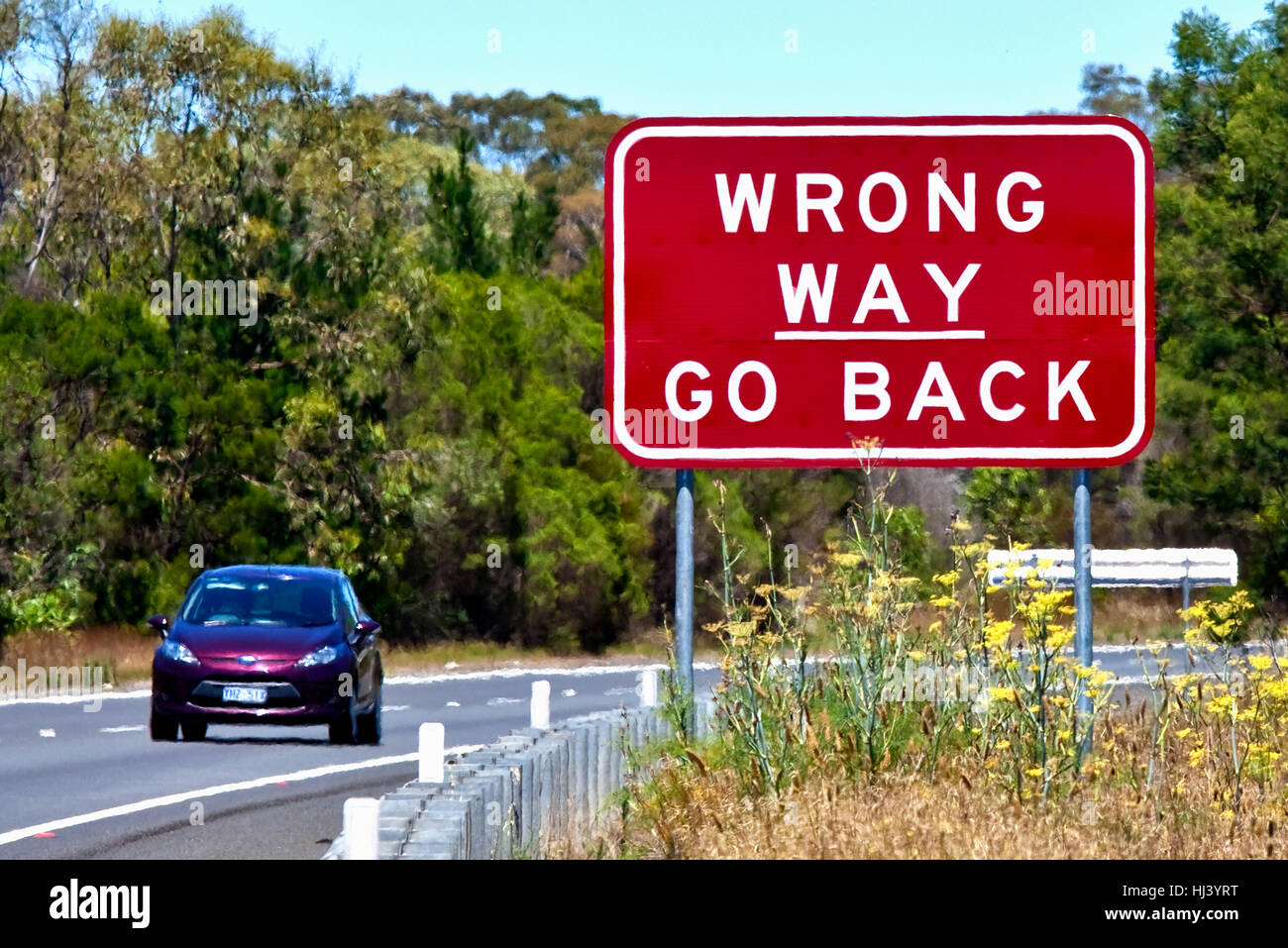 Road sign warning - Wrong way go back on Hume Highway, Australia Stock Photo