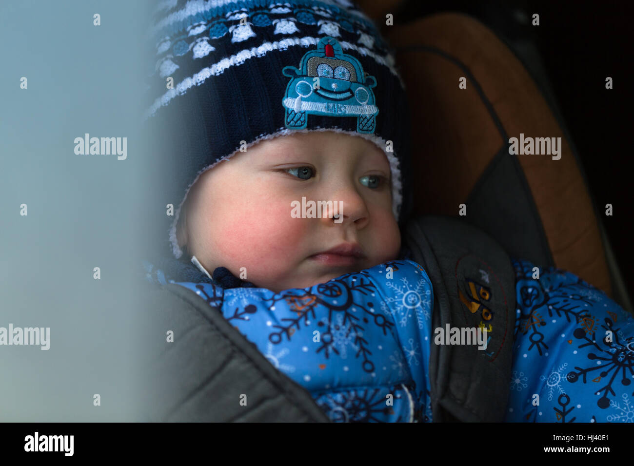 little boy in winter clothes in a child car seat Stock Photo Alamy