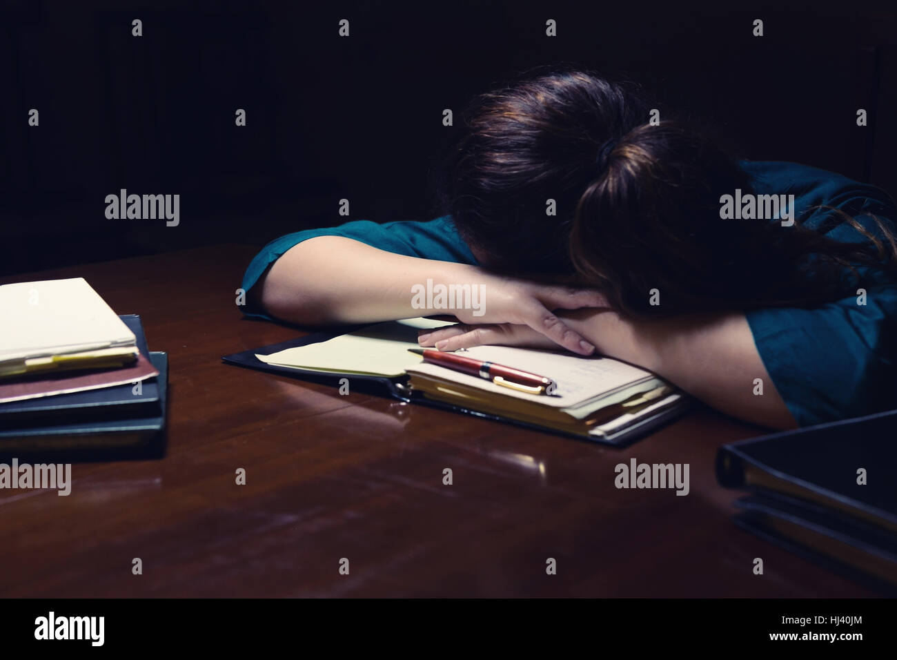 Tired young lady sleeping on her books Stock Photo