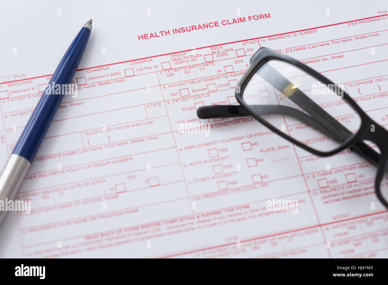 Health insurance claim form with pen and glasses Stock Photo Alamy
