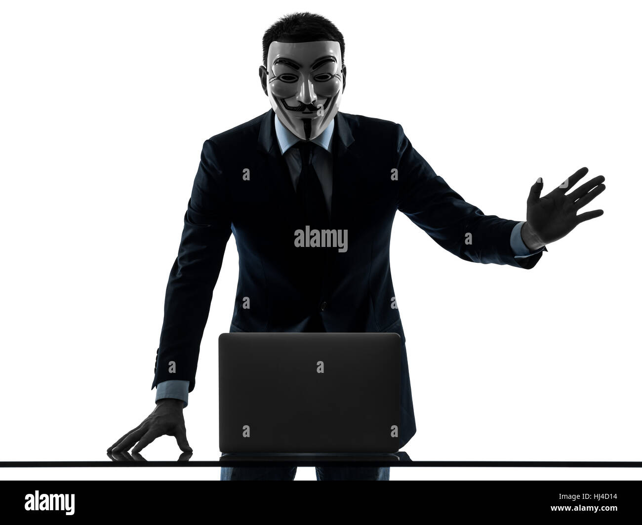 PARIS– OCTOBER 30 : one man dressed and masked as a  member of Anonymous underground group member computing computer  saluting on October 30, 2012 in Paris ,France Stock Photo