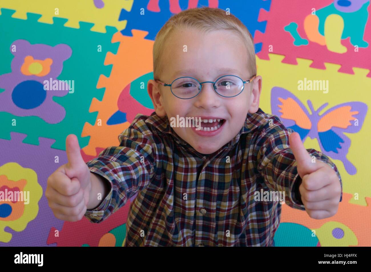 Little boy showing both thumbs Stock Photo