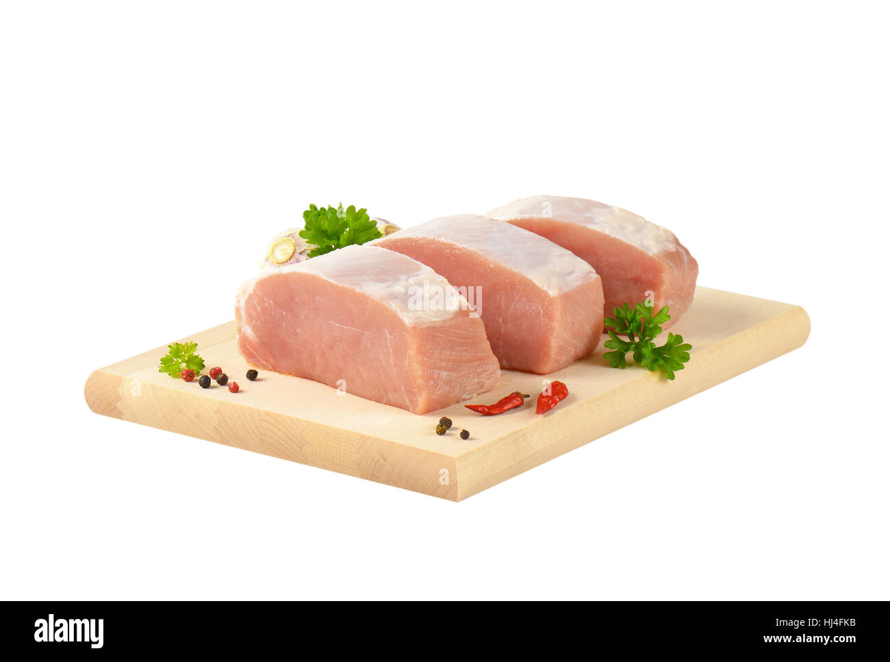 Slices of fresh boneless pork loin on cutting board Stock Photo