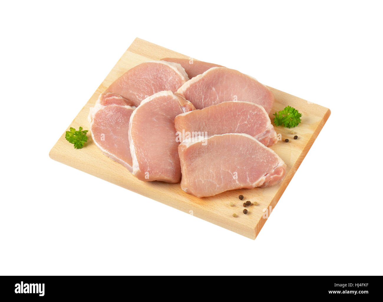 raw boneless pork loin chops on cutting board Stock Photo