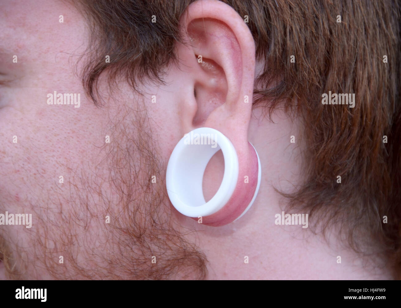 Man with ear piercing Stock Photo Alamy