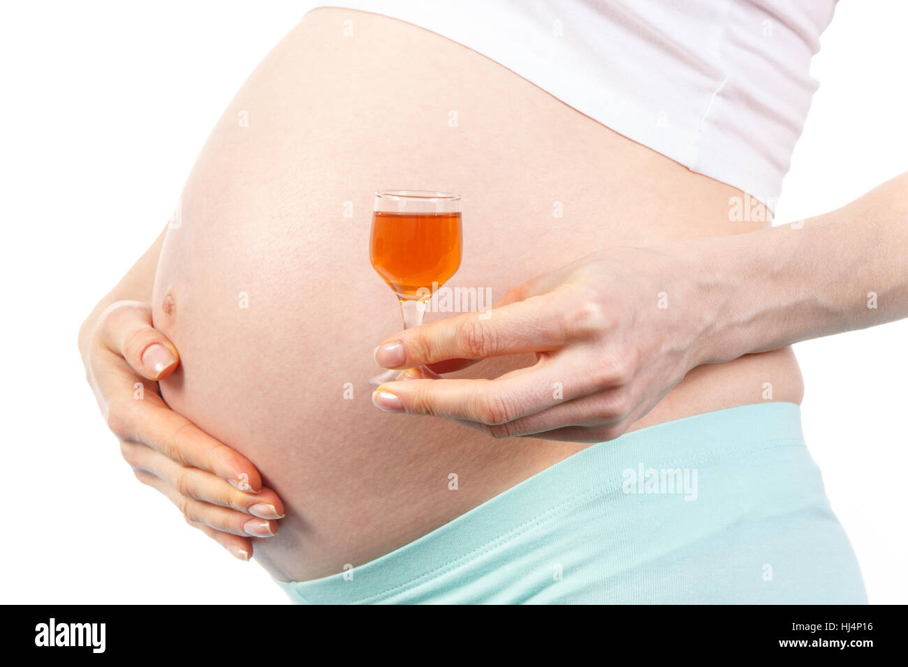 Pregnant woman with glass of wine, concept of unhealthy lifestyles