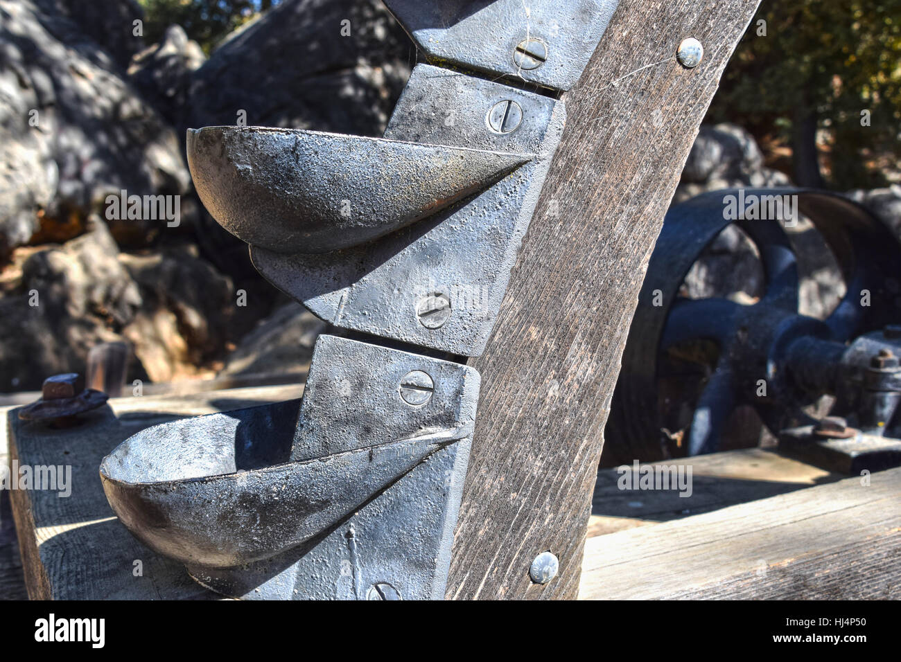 Old wooden water wheel with iron buckets Stock Photo