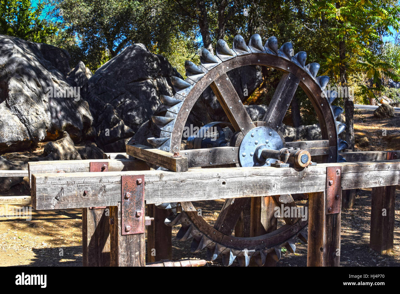 Old wooden water wheel with iron buckets Stock Photo