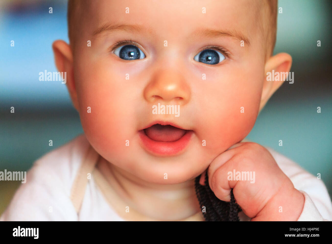 Beautiful smiling cute baby girl,pink cheeks, blue eyes, open mouth ...