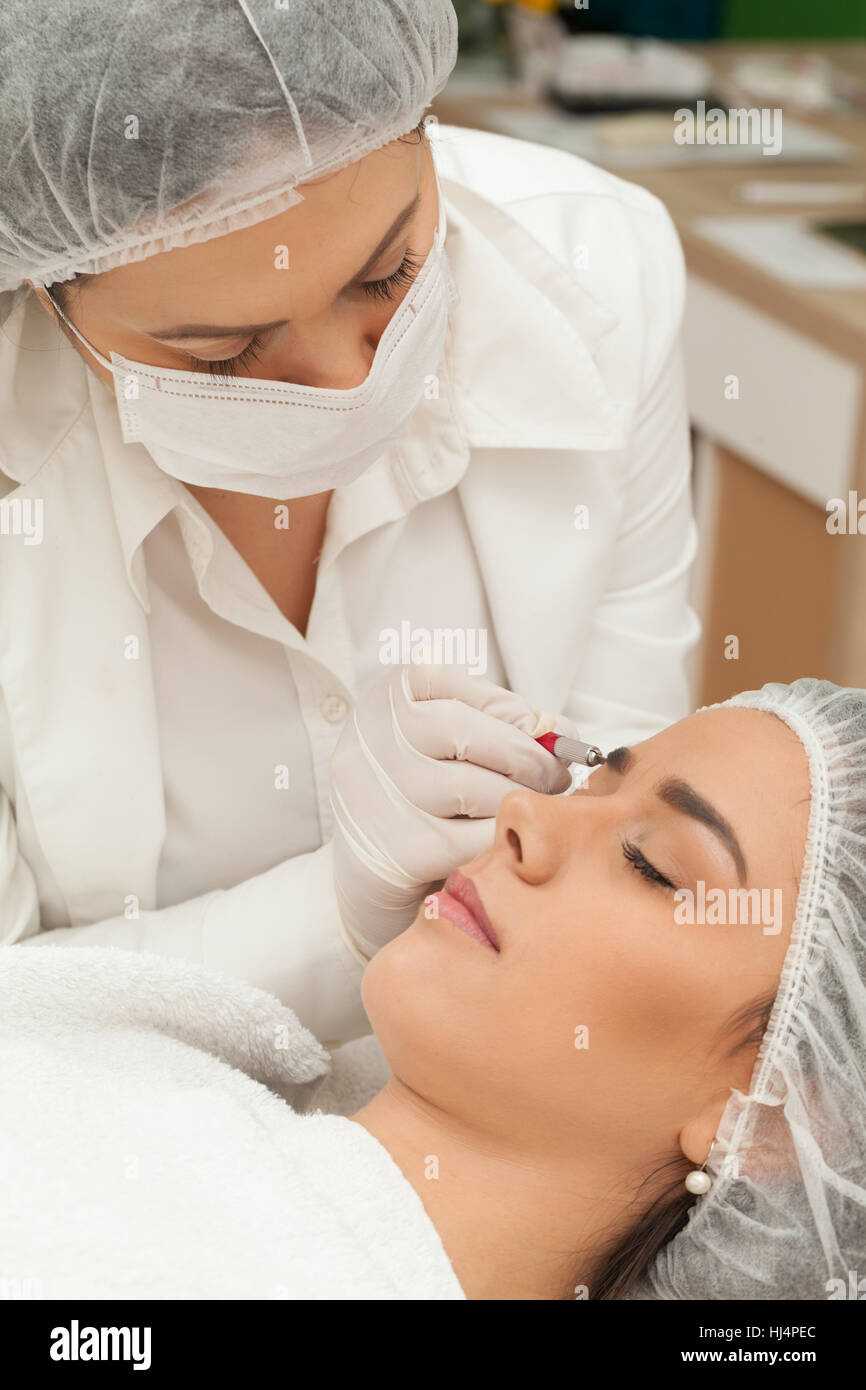 Permanent make up eyebrows in beauty salon Stock Photo
