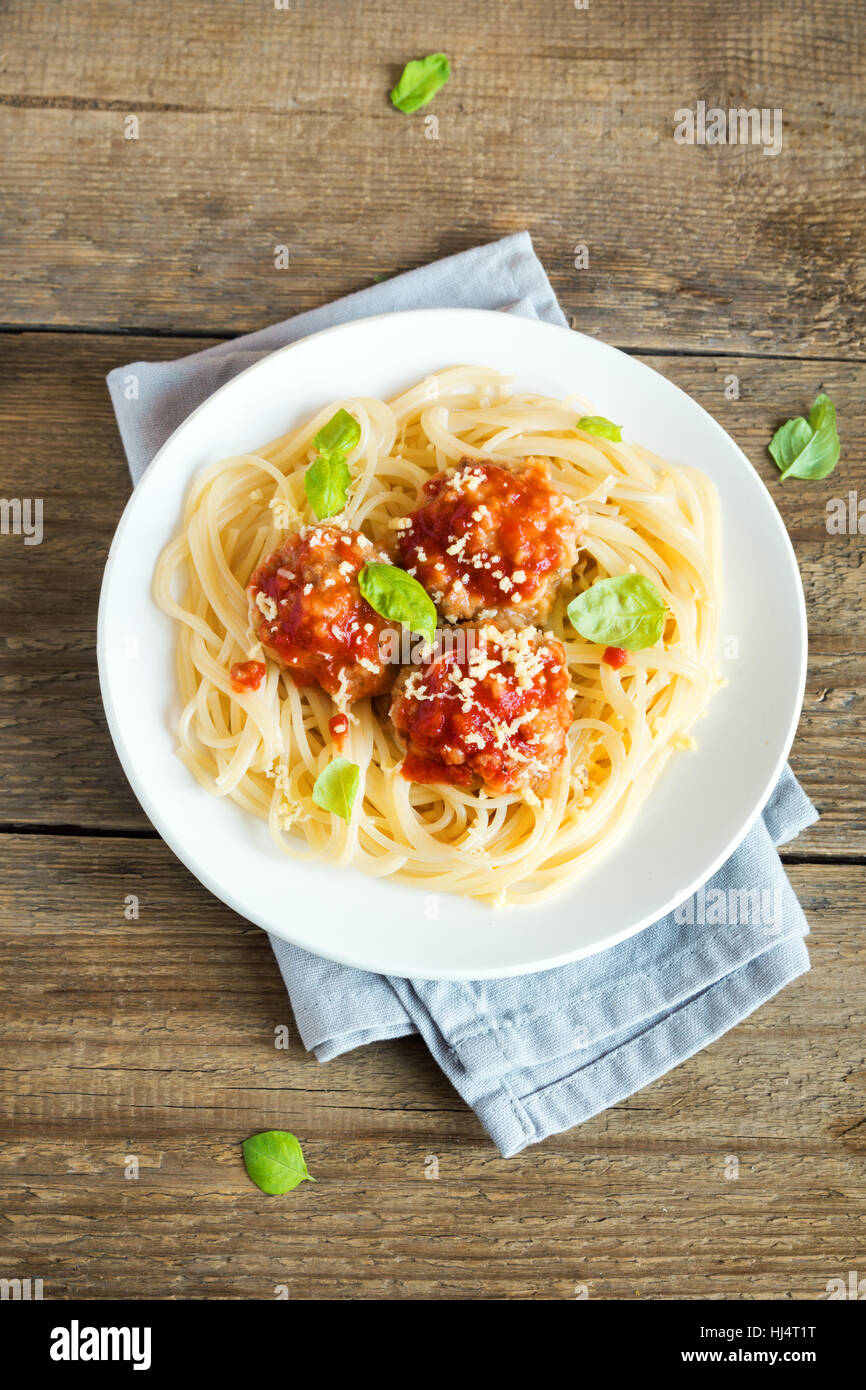 Spaghetti pasta with meatballs, tomato sauce, grated parmesan cheese