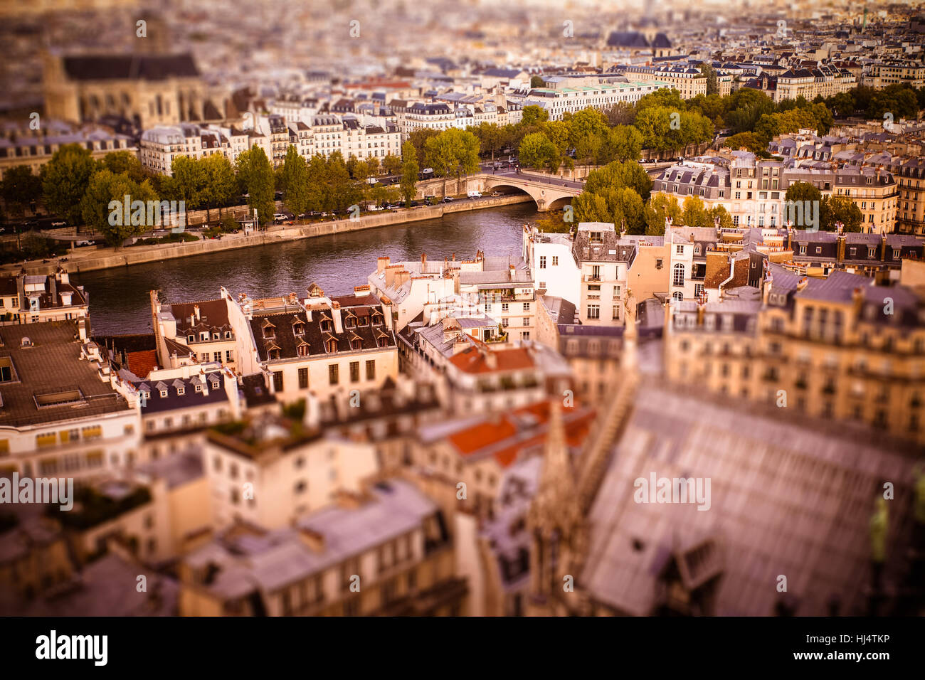Tilt-shift miniature view across rooftops in Paris toward River Seine Stock Photo