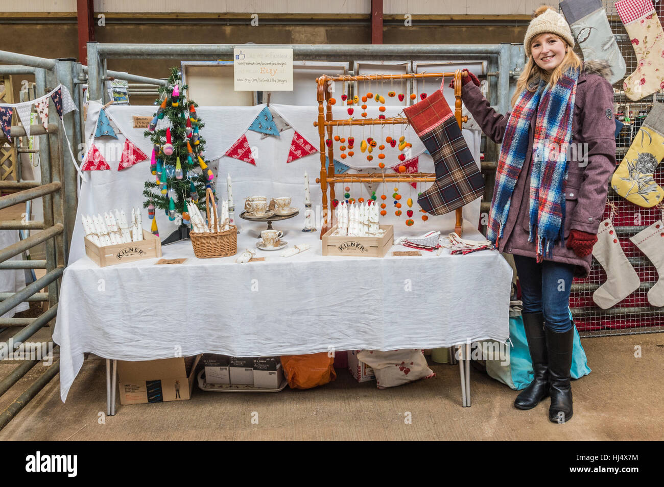 Young woman managing her stall of hand made crafts at a traditional ...