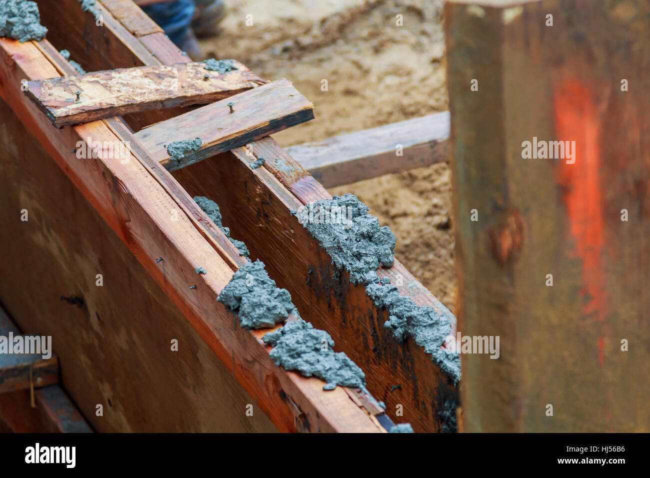 Closeup of foundation excavation with fresh poured concrete and