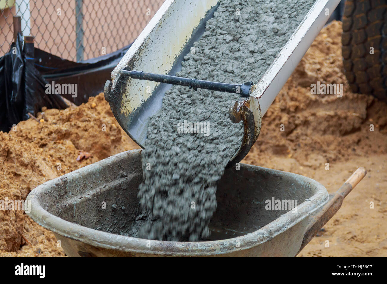 Wheelbarrow with shovel full of cement Concrete wheelbarrow Stock Photo