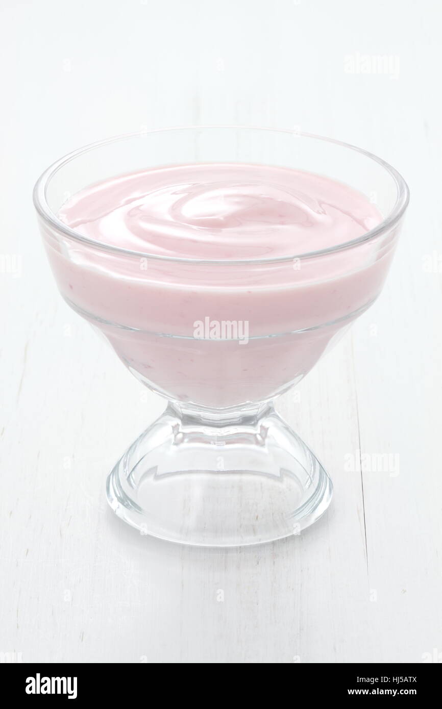 Fresh, healthy and delicious creamy, strawberry yogurt in vintage French cup, the perfect snack or dessert. Stock Photo