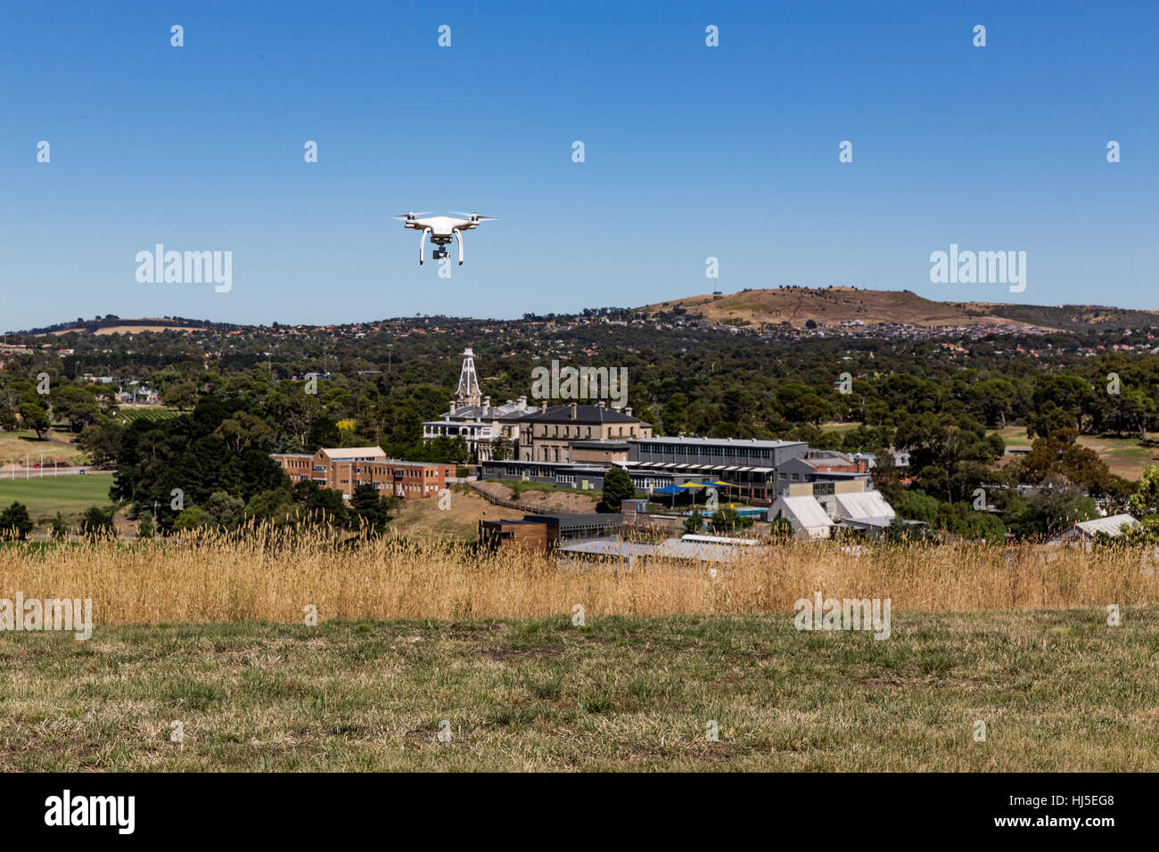 Unmanned Aerial Vehicle (UAV) or Drone, safely flying in a field. Stock Photo
