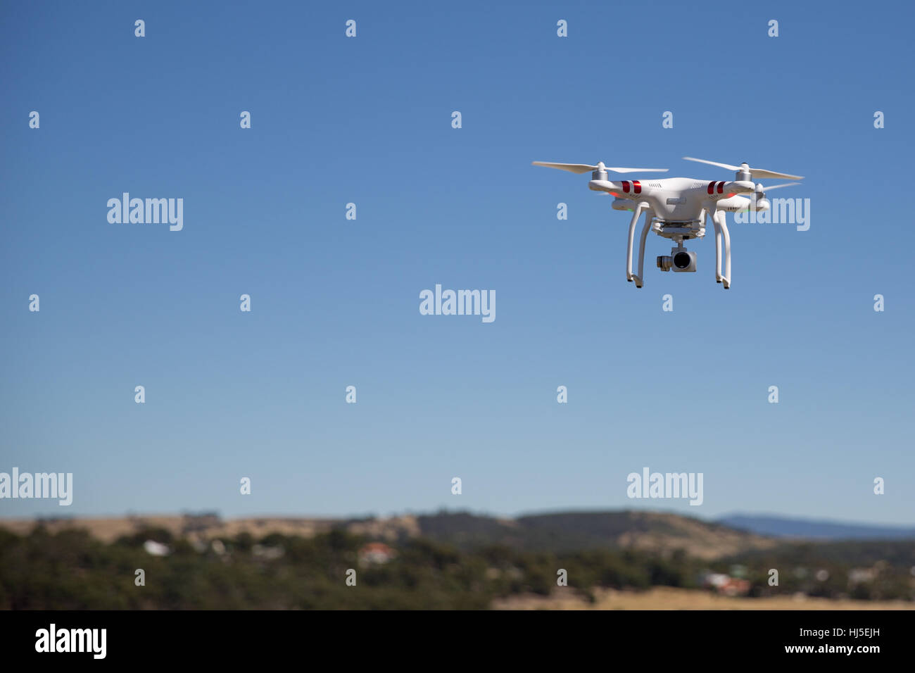 Unmanned Aerial Vehicle (UAV) or Drone, safely flying in a field. Stock Photo