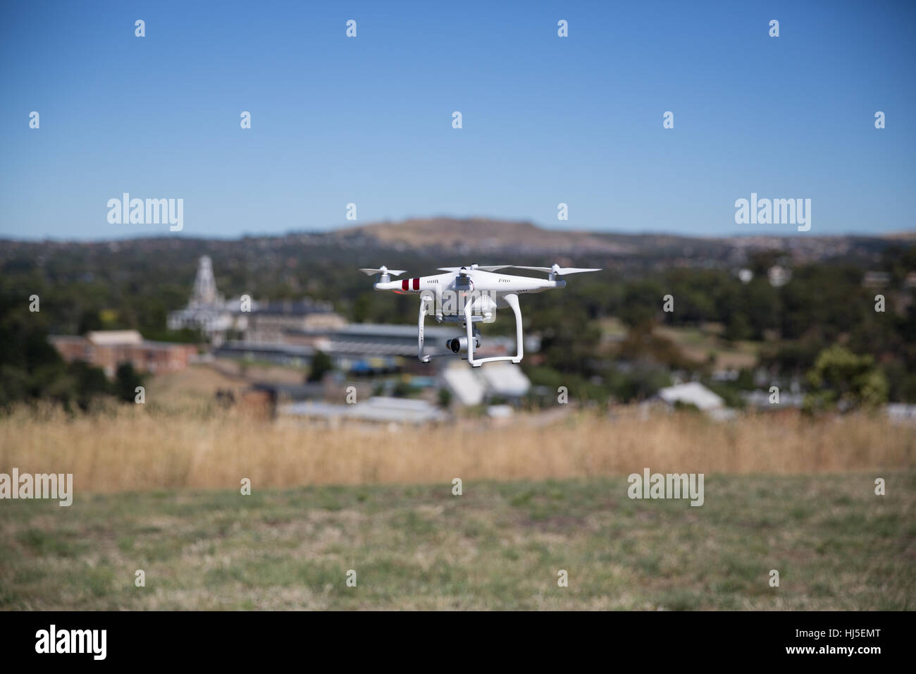 Unmanned Aerial Vehicle (UAV) or Drone, safely flying in a field. Stock Photo