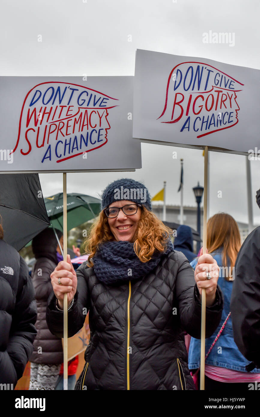 San Francisco, California, USA. 21st January, 2017. Woman holds signs about not giving bigotry or white supremacy a chance at San Francisco Women's March 2017, smiling, January 21, 2017. Credit: Shelly Rivoli/Alamy Live News Stock Photo