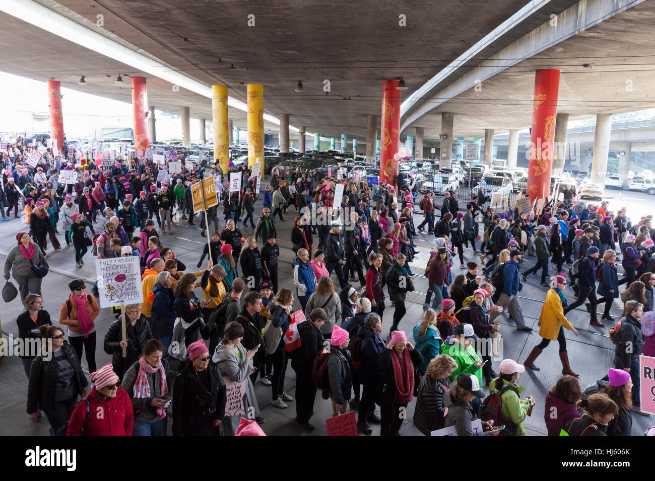 Seattle, United States. 21st Jan, 2017. Seattle, Washington: Supporters march through the International District under I-5. Over 100,000 people attended the Womxn's March on Seattle on January 21, 2017 in solidarity with the national Women's March on Washington, DC The mission of the silent march is to bring diverse women together for collective action. Credit: Paul Gordon/Alamy Live News Stock Photo