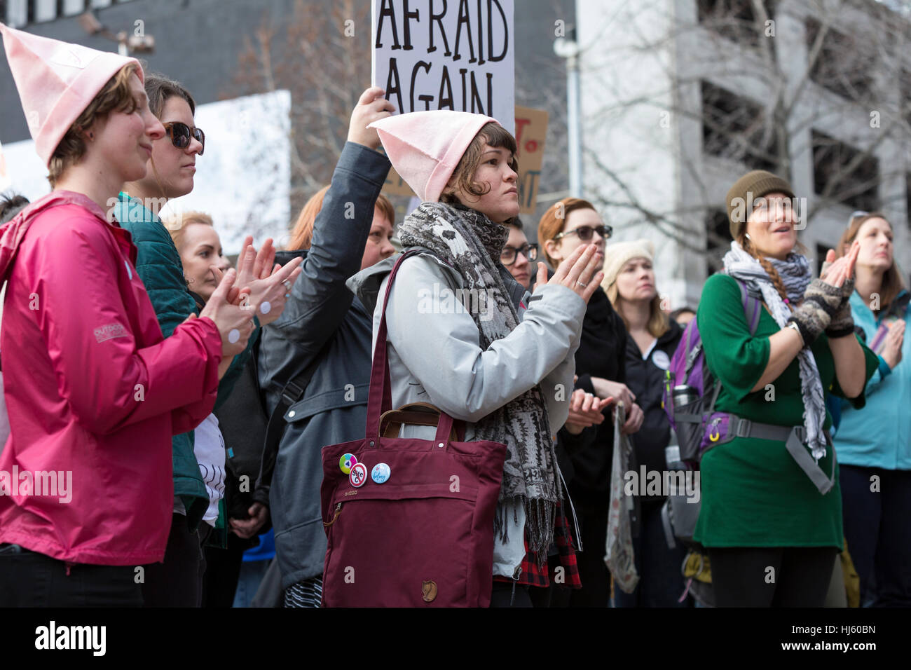 Seattle, United States. 21st Jan, 2017. Seattle, Washington: Supporters clap for a speaker as they pass through downtown. Over 100,000 people attended the Womxn's March on Seattle on January 21, 2017 in solidarity with the national Women's March on Washington, DC The mission of the silent march is to bring diverse women together for collective action. Credit: Paul Gordon/Alamy Live News Stock Photo