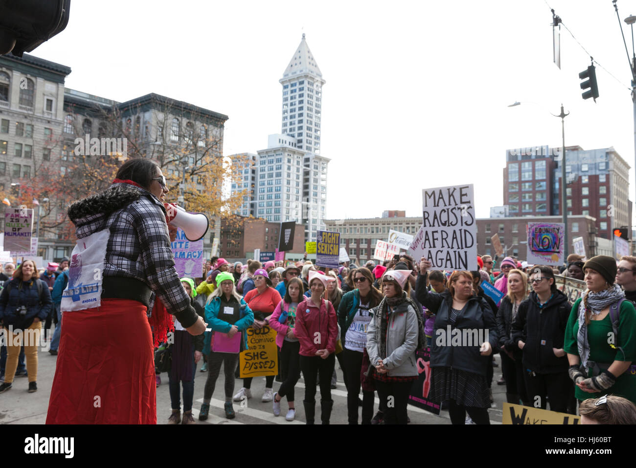 Seattle, United States. 21st Jan, 2017. Seattle, Washington: Woman speaks to supporters as they pass through downtown. Over 100,000 people attended the Womxn's March on Seattle on January 21, 2017 in solidarity with the national Women's March on Washington, DC The mission of the silent march is to bring diverse women together for collective action. Credit: Paul Gordon/Alamy Live News Stock Photo