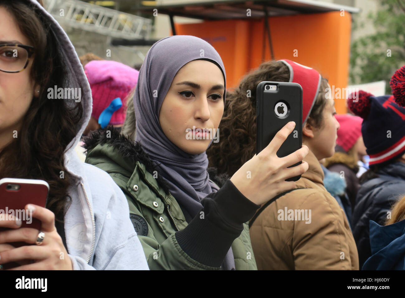 Muslim woman with iPhone during the Women's march in Washington Stock Photo