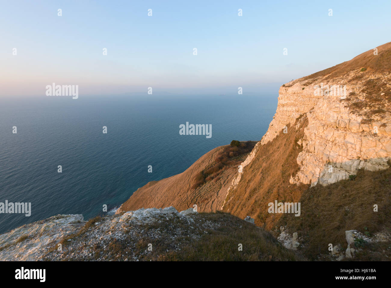 View from White Nothe, Dorset, UK. A colourful winter sunrise looking towards Portland and Weymouth from high up on the white chalk cliffs of White Nothe in Dorset. © Dan Tucker/Alamy Live News Stock Photo