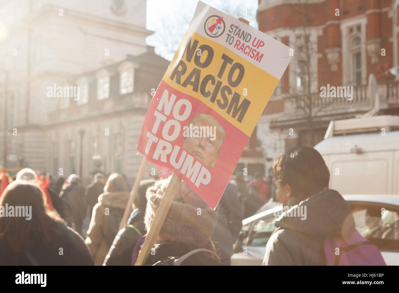 London, UK. 21st January, 2017. Protestors on Women's March marching through streets of London holding anti racist placard. Credit: Alan Gignoux/Alamy Live News Stock Photo