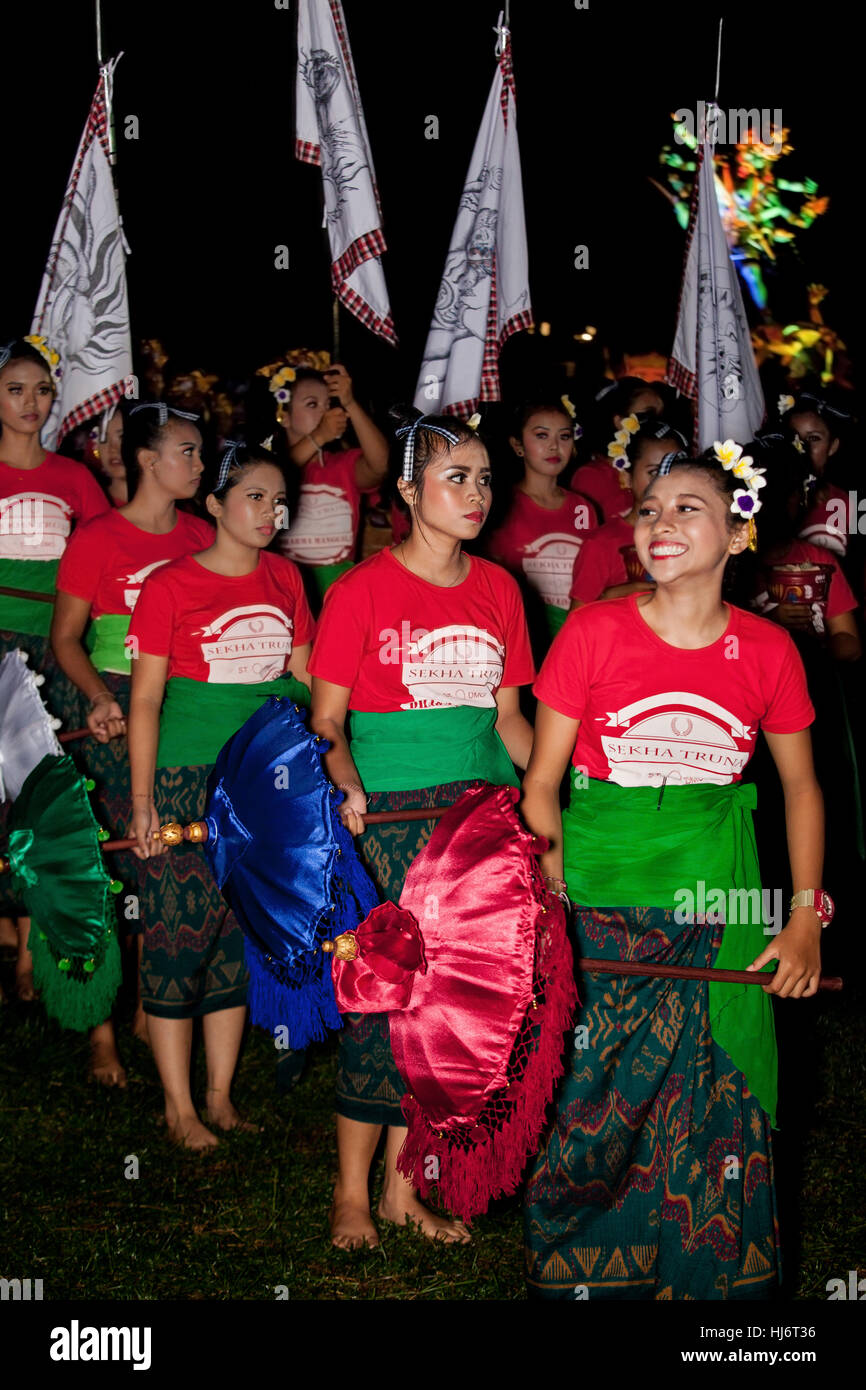 Beautiful Balinese Girls lead the Ogoh-Ogoh procession at Balinese New Year's Eve Stock Photo