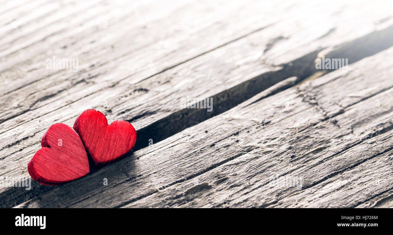 Two small wooden red hearts on old cracked wood background Stock Photo ...