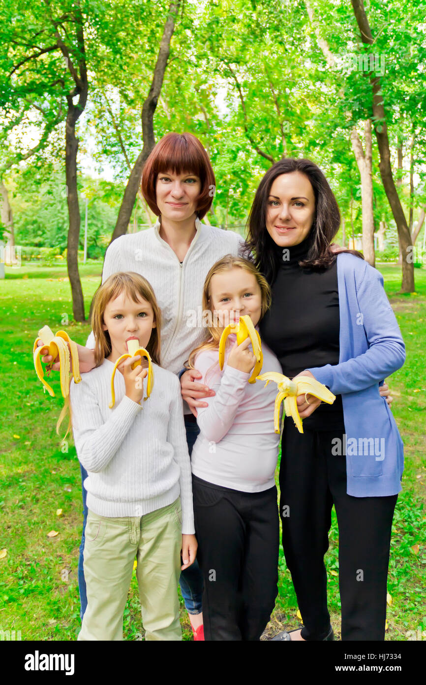 Photo of group people are eating bananas Stock Photo