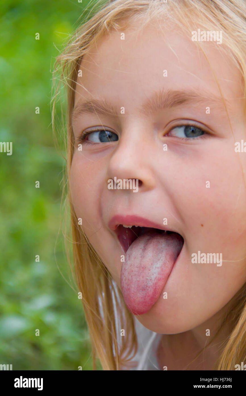 Portrait of cute girl with put out tongue Stock Photo