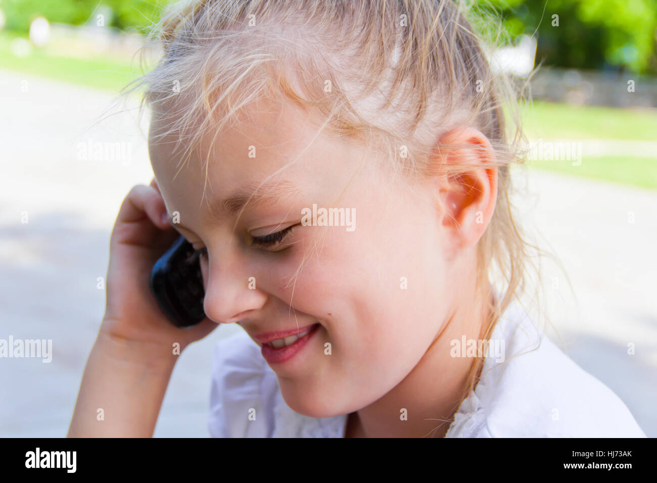 Photo of cute girl talking by cellular Stock Photo