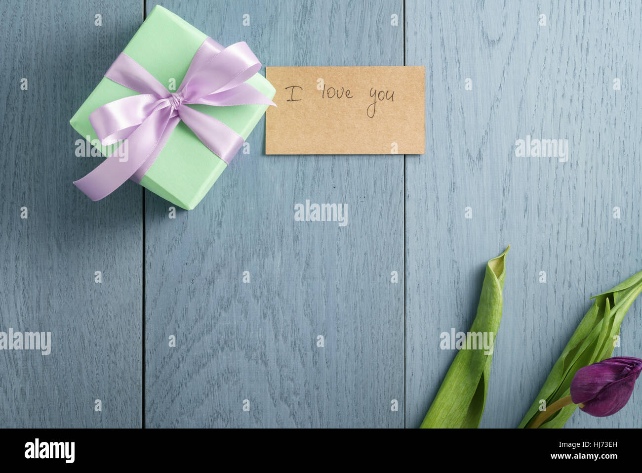 green gift box on blue wood table with paper card i love you Stock Photo